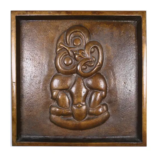A heavy bronze tiki tray,
